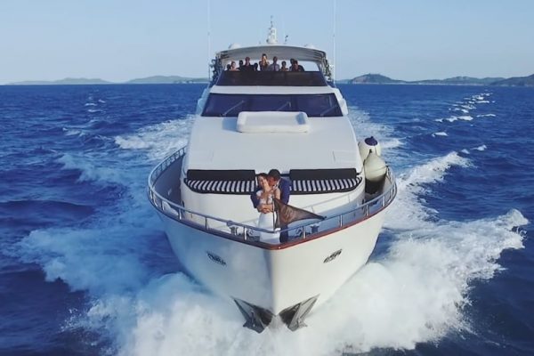 bride and groom on the front of 100ft luxury yacht drone