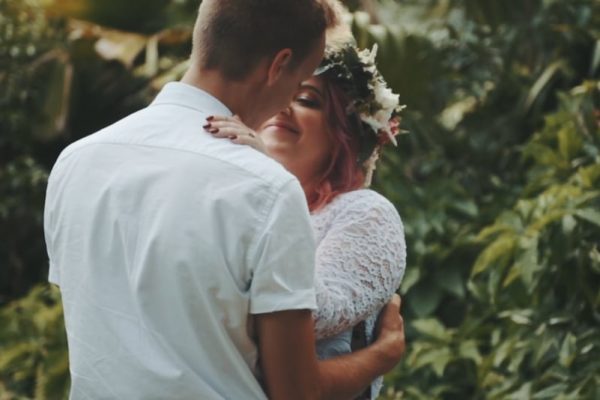 bride and groom embracing in rainforest