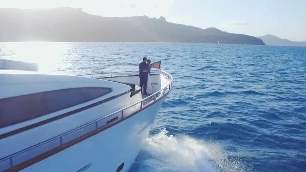 bride and groom on luxury yacht drone