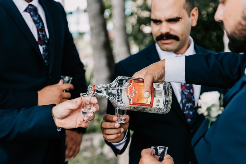 groomsmen pouring tequila