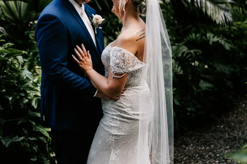 bride and groom bride touching groom