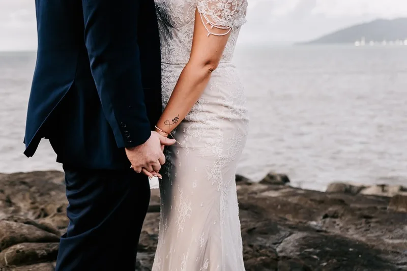bride and groom holding hands