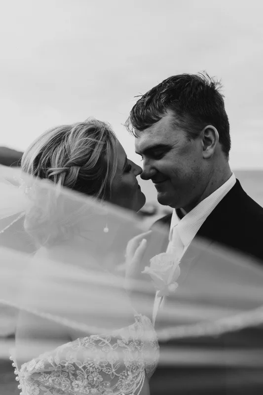 bride and groom black and white photo with veil