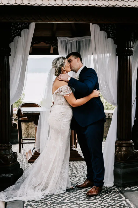 bride and groom first kiss