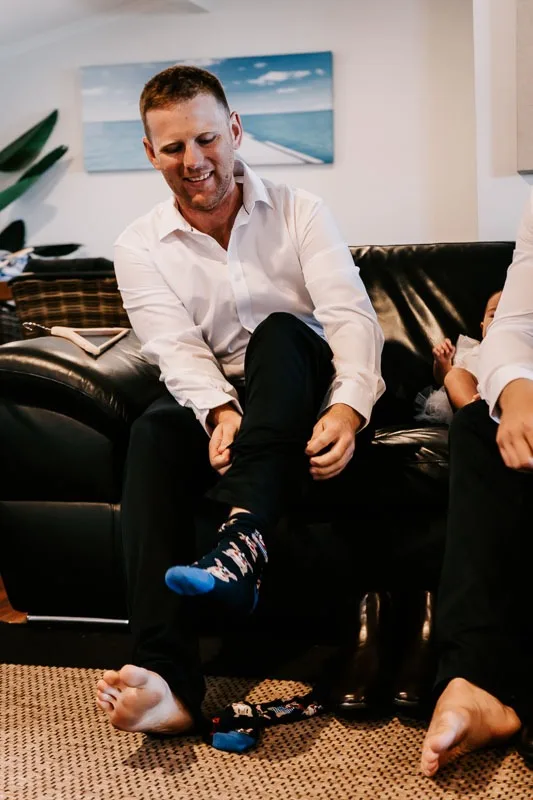groom putting on socks