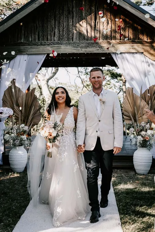 bride and groom recessional with petals