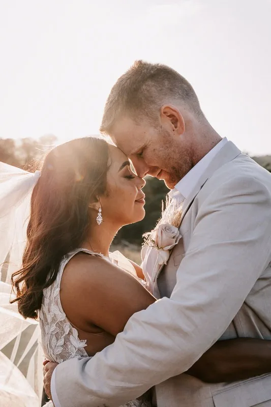 bride and groom sunset eyes closed