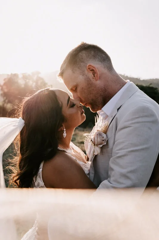 bride and groom sunset eyes closed