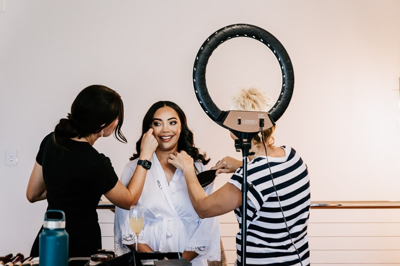 bride getting hair and makeup done