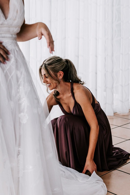 bridesmaid adjusting dress