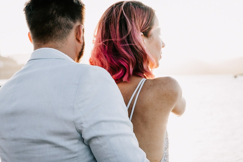 bride and groom on boardwalk sunset