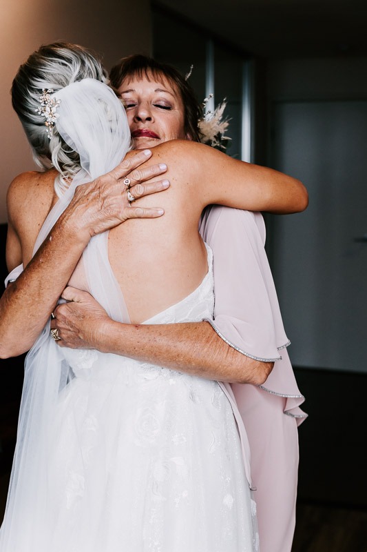 bride and mum hugging