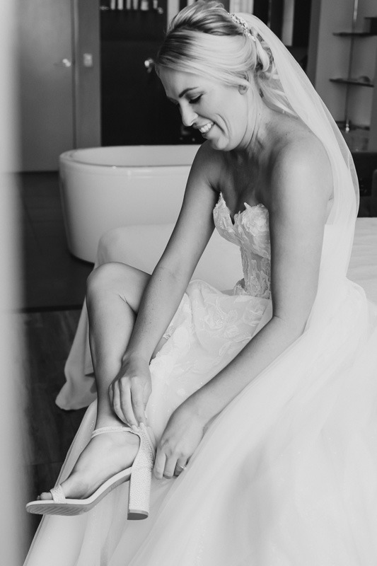 bride doing up her shoes