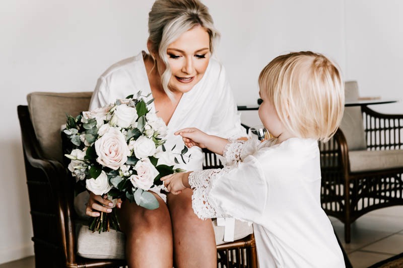 bride and daughter with bouquet