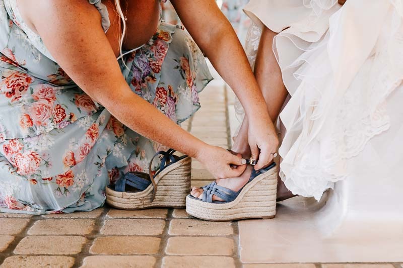 bride putting on bllue shoes