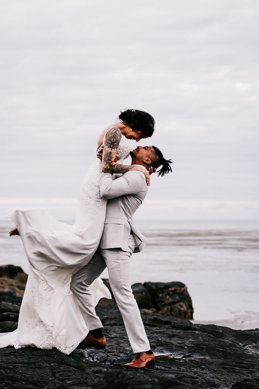 bride and groom on rocks