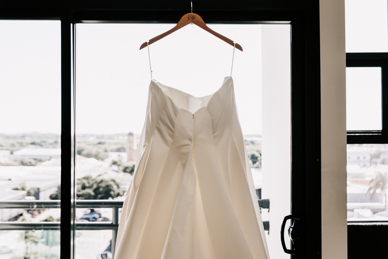 brides dress hanging in the window