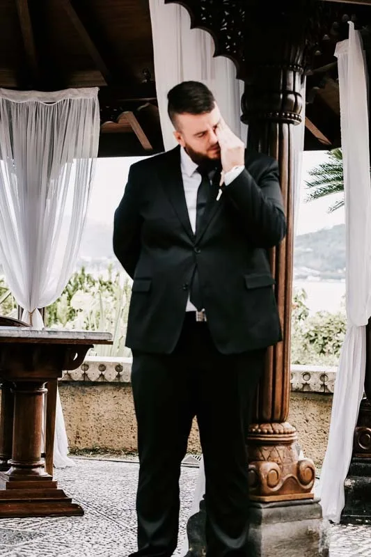 groom wipes away tears