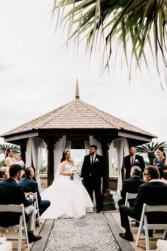 bride and groom stading at pavillion