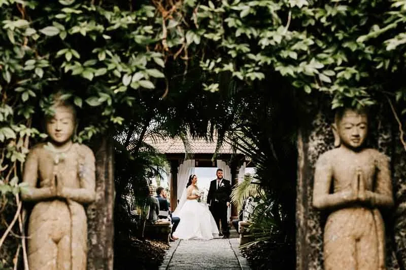 bride and groom at alter long view with greenery