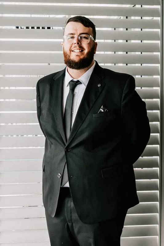 groom posing and smiling