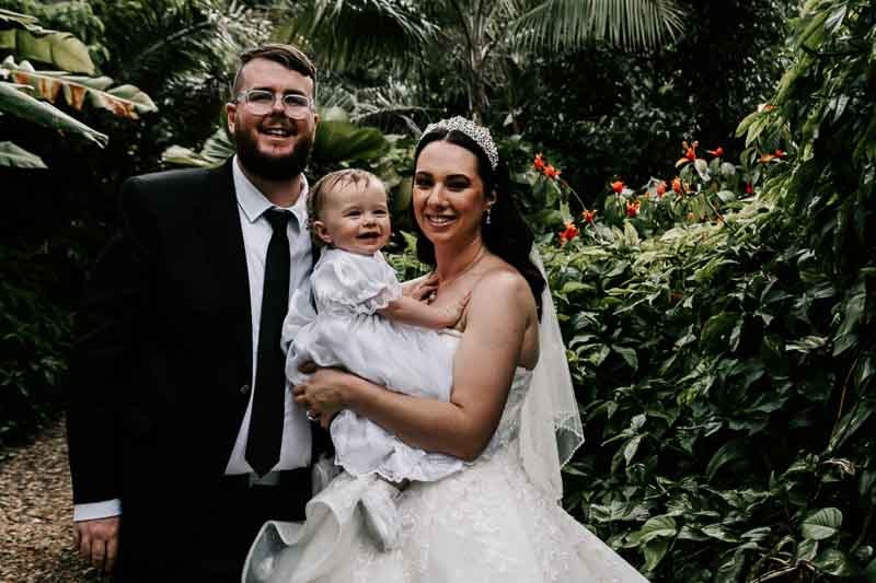 bride and groom with daughter