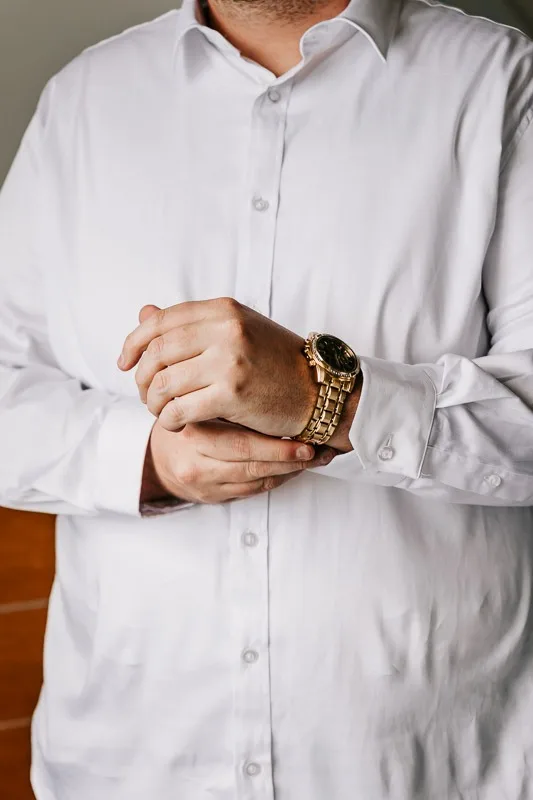 groom putting on watch