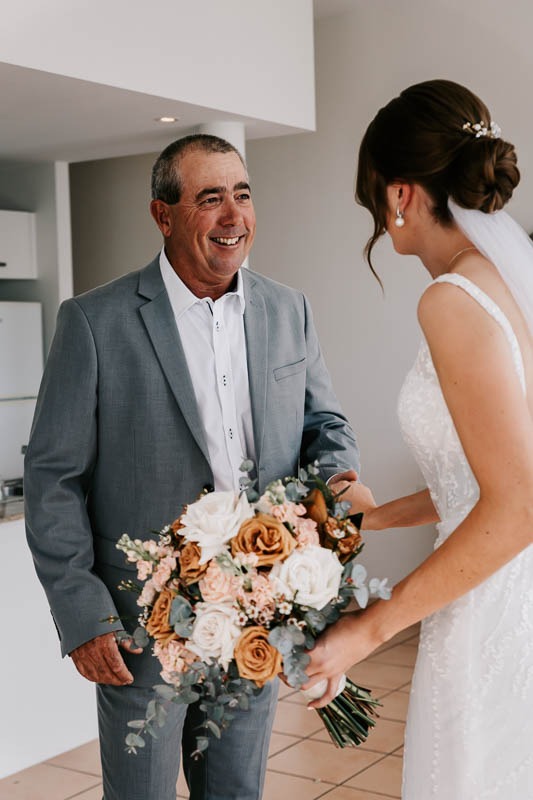 father smiling with bride