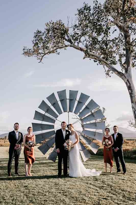 bridal party in front of windmill fan