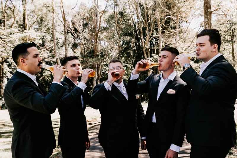 Groom and groomsmen drinking beer
