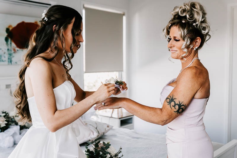 Bride putting on corsage