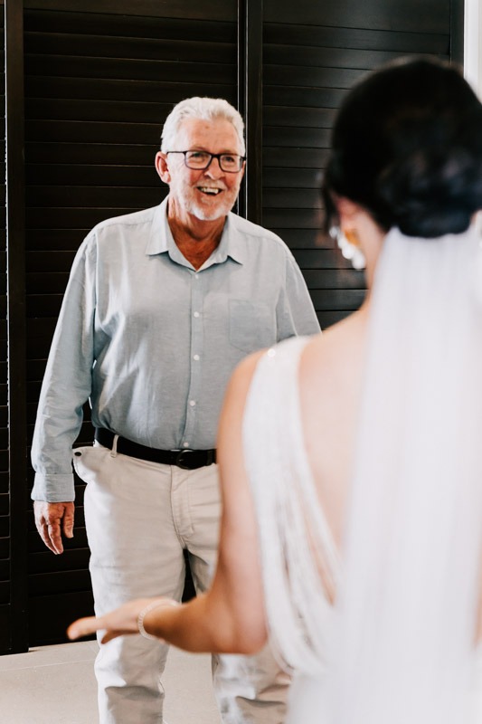 Father smiling at bride