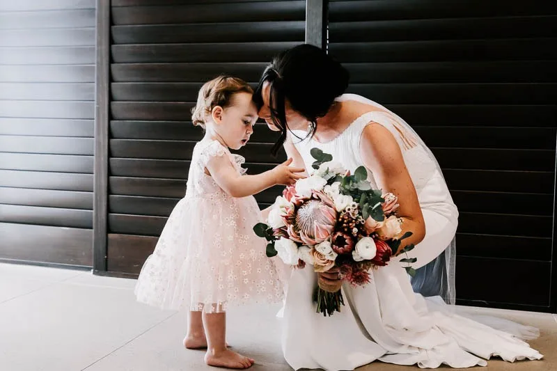 Bride kissing child