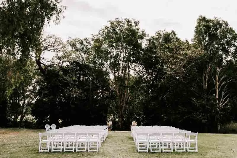 Ceremony chairs in bush setting wide
