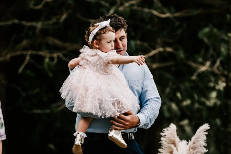 Groom and child pointing