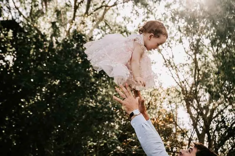 Groom catching child