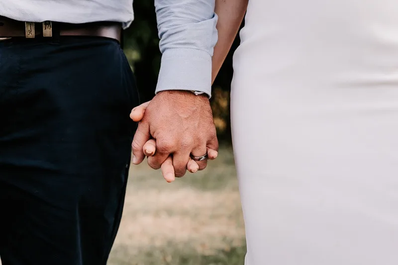 Bride & Groom holding hands close up