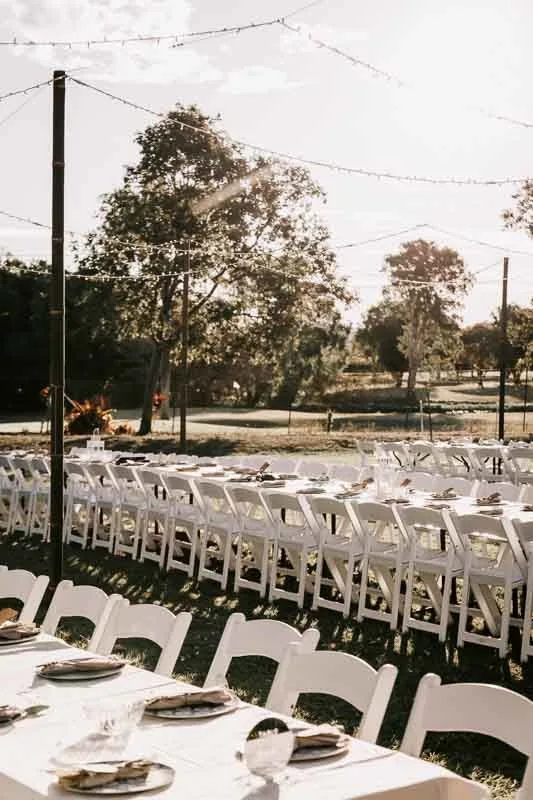 Reception set up with tables, chairs and lights