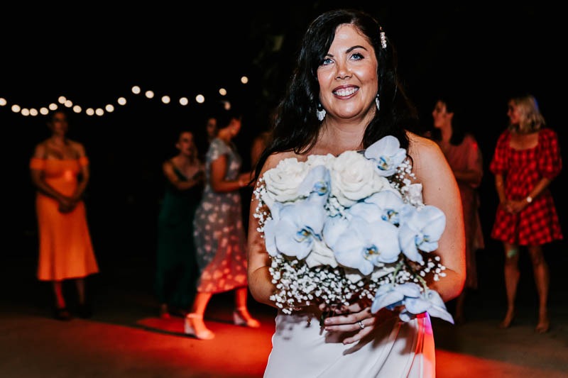 Bride holding bouquet smiling