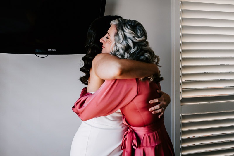 Bride hugging mother