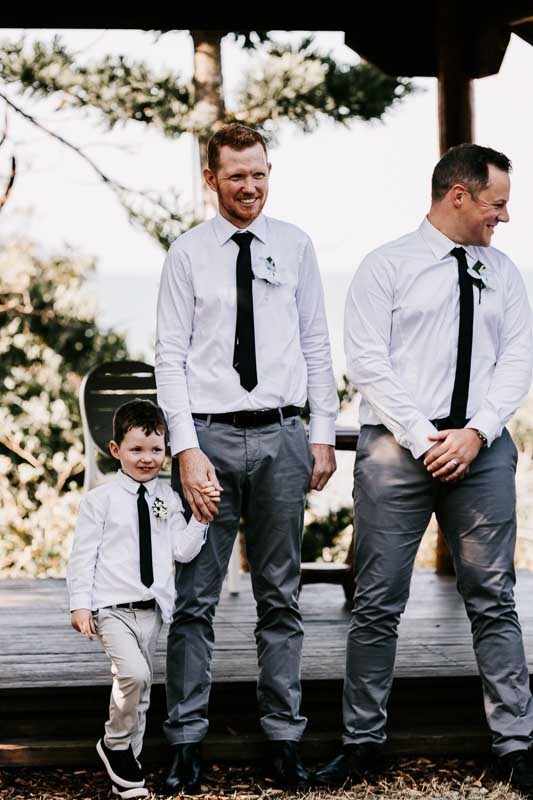 Groom holding young boys hand