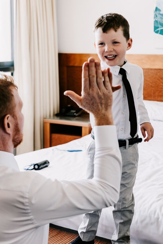 Groom high five with child