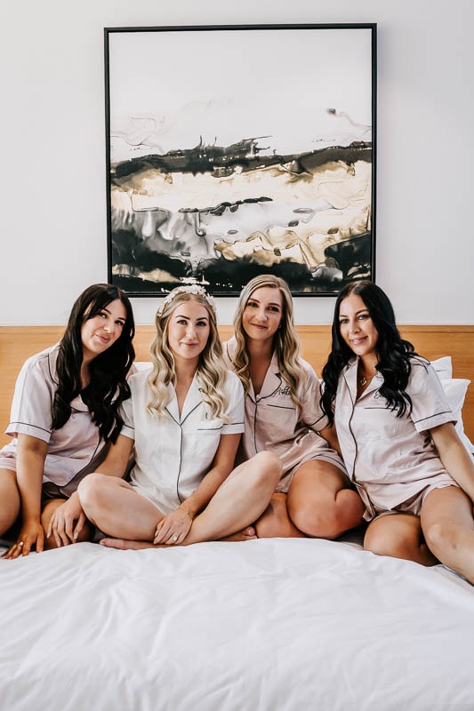 Bride and bridesmaids on bed