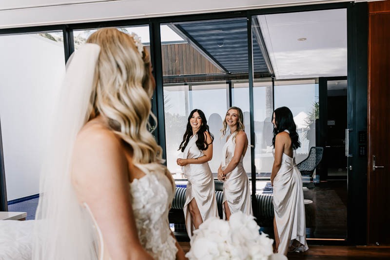 Bridesmaids see bride in gown