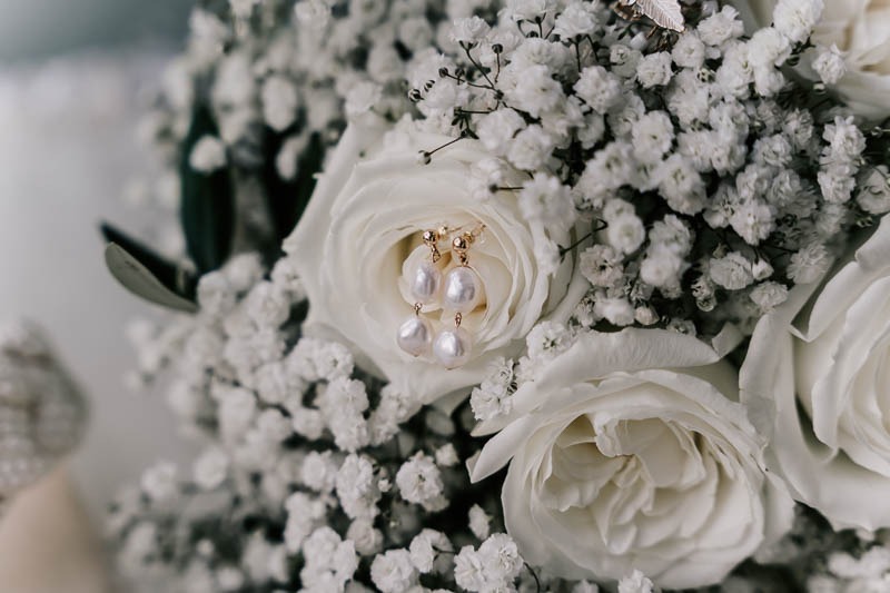 Brides earrings on bouquet