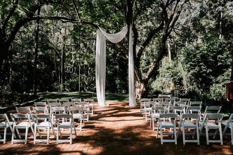 Ceremony setting under canopy of trees