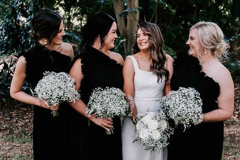 Bride and bridesmaids smile together