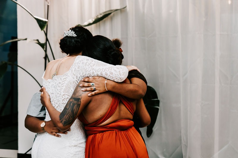 Bride and women embrace