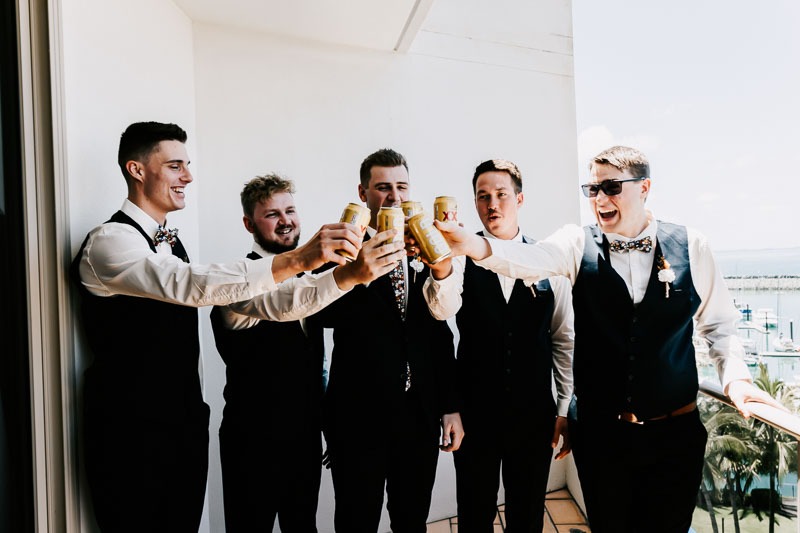 Groom and groomsmen cheers drinks
