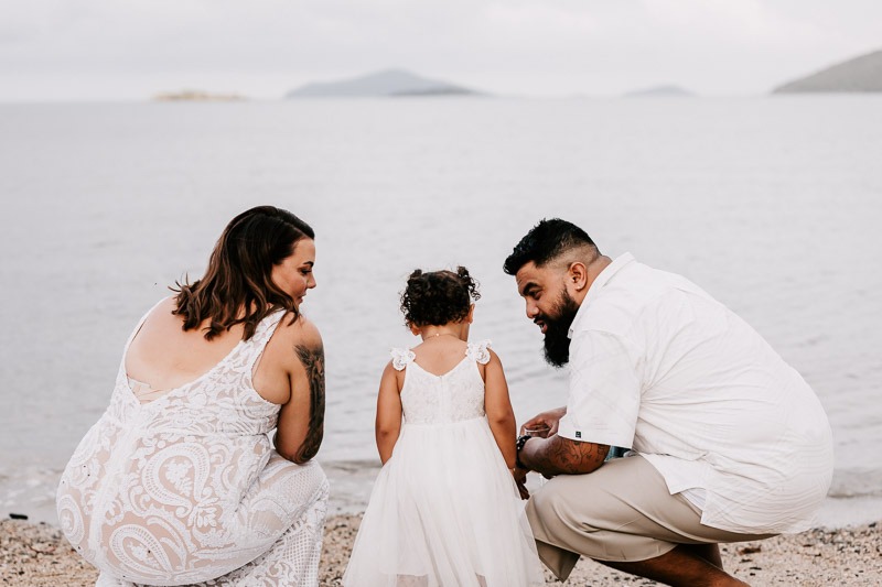 Bride & Groom on beach with daughter